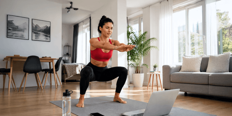Person performing a bodyweight calisthenics exercise at home as part of a 30-day workout plan